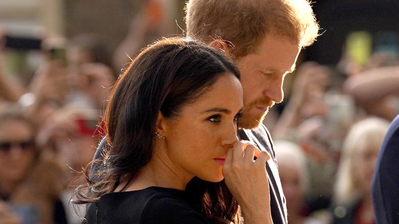 Meghan Markle and Harry looking away 