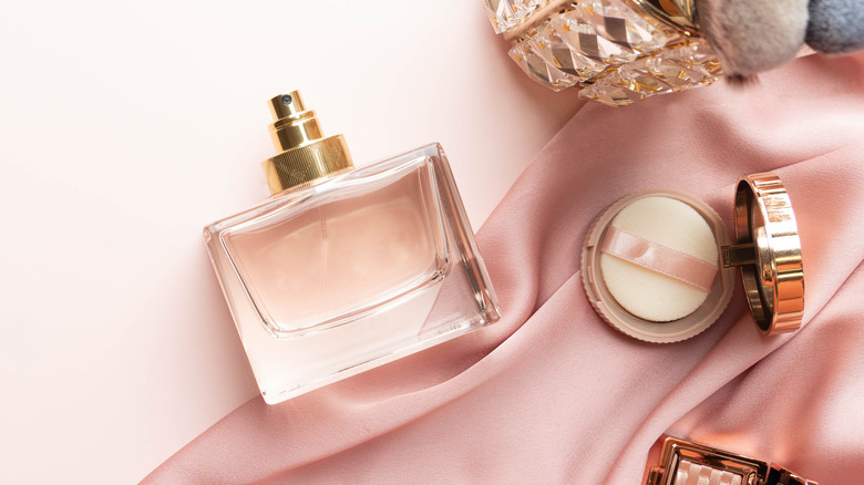 Perfume bottle and pink silk