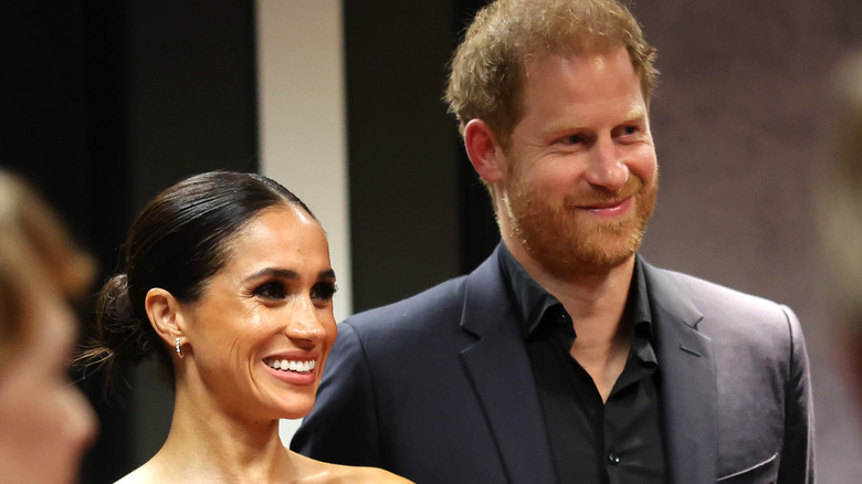 Meghan Markle smiling with Prince Harry