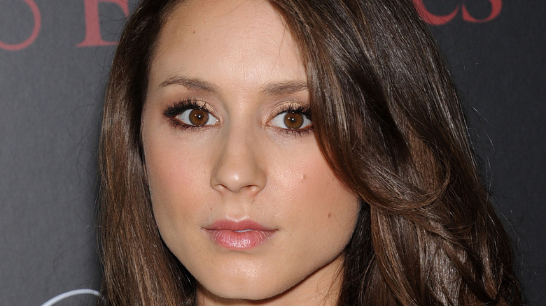 Troian Bellisario posing for a picture at an event in 2014