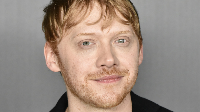Rupert Grint giving the camera a half smile