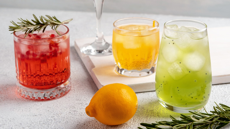 cocktails on table with rosemary and lemon