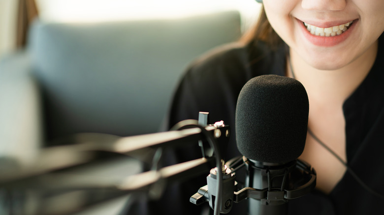 Woman at a podcast microphone