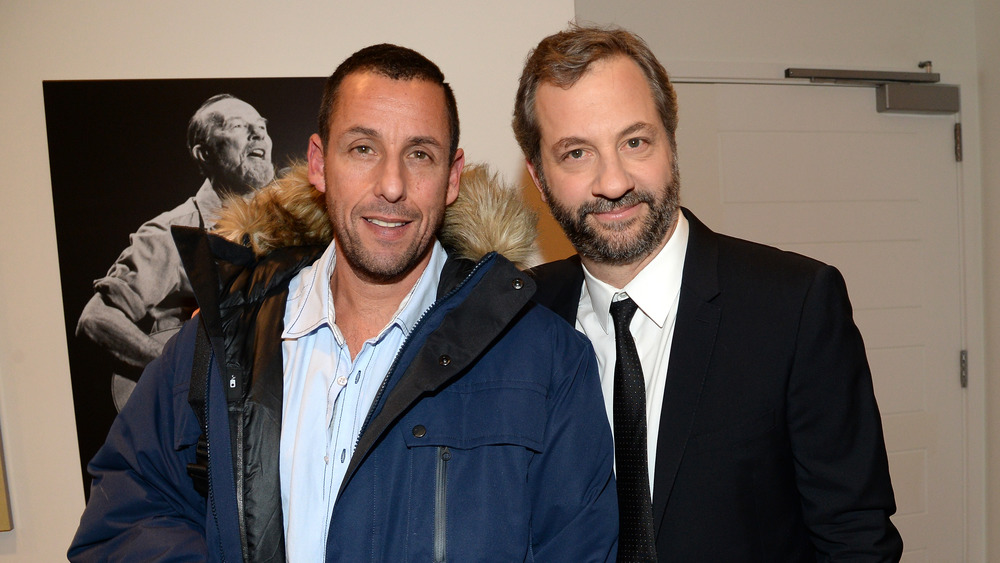 Adam Sandler and Judd Apatow smile at an event