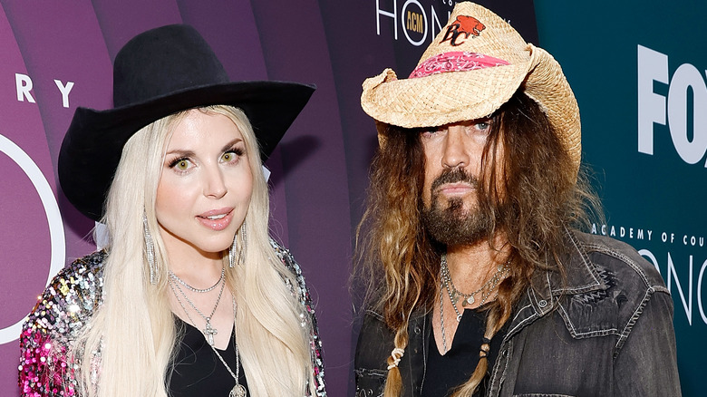 Firerose and Billy Ray Cyrus on red carpet in cowboy hats
