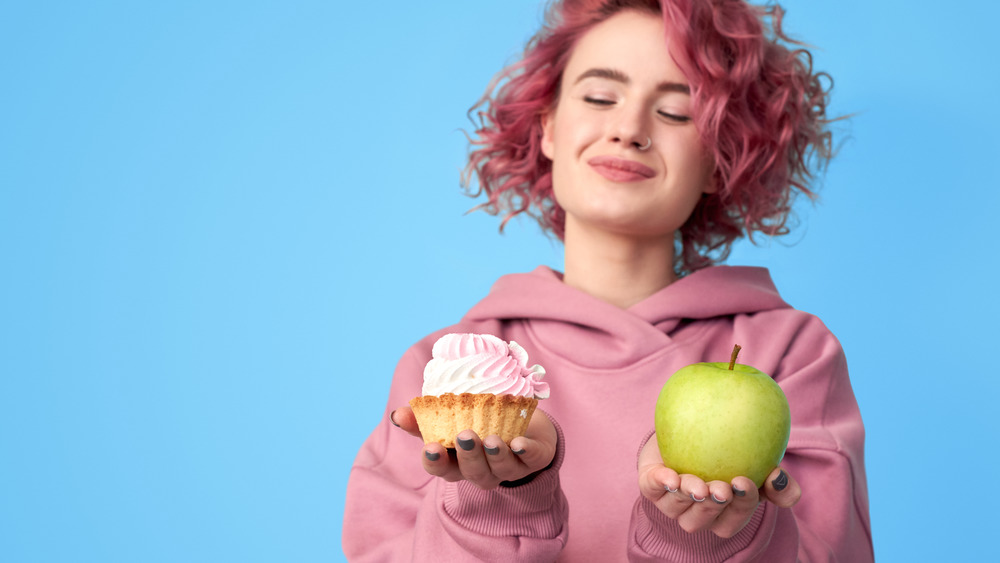 Woman with apple and cupcake