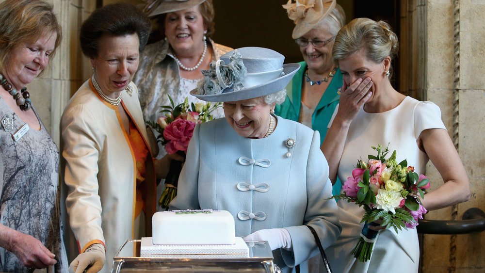 Queen Elizabeth II being presented with a cake by the Women's Institute