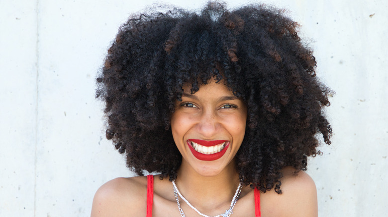 Woman with afro smiling