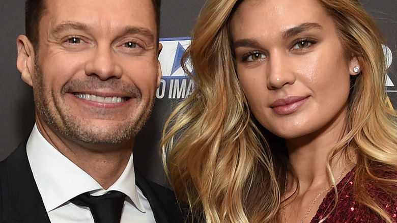 Ryan Seacrest smiles with Shayna Taylor