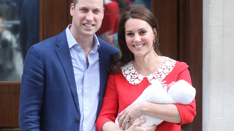 Prince William and Catherine holding baby Louis