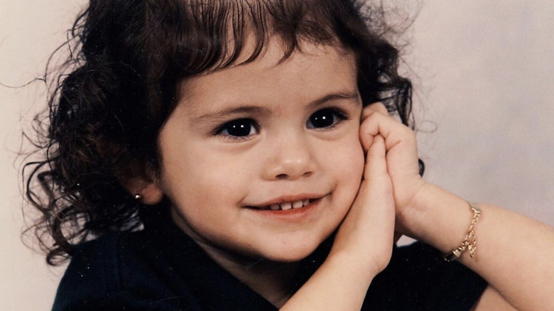 Selena Gomez as a young girl, wearing black