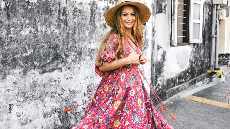 Woman wearing maxi dress and hat on street