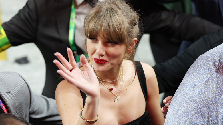 Taylor Swift waving at the Super Bowl 