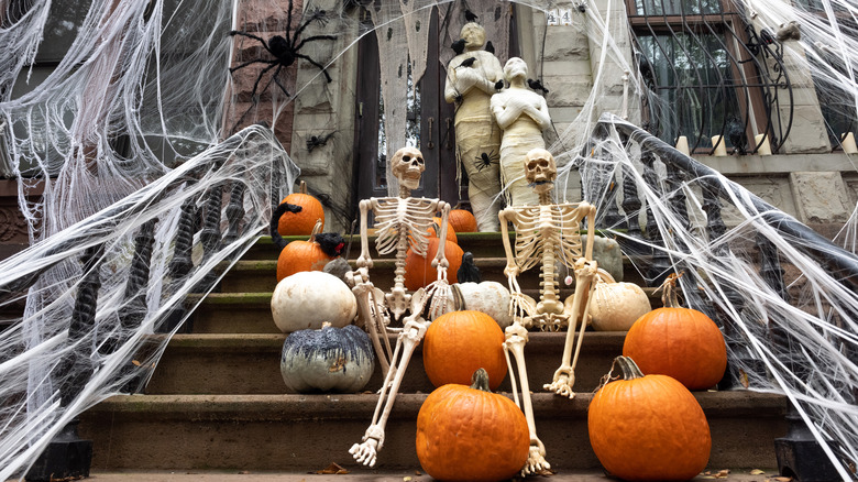 home in new york decorated for halloween with spiders, skeletons, mummies, pumpkins, and spiderwebs