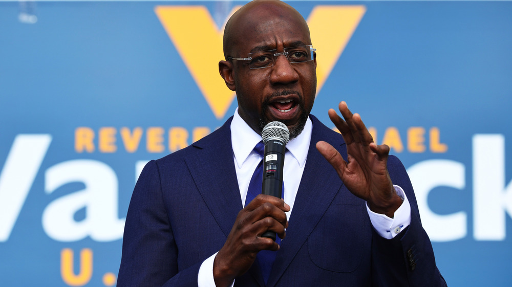 Raphael Warnock with a microphone