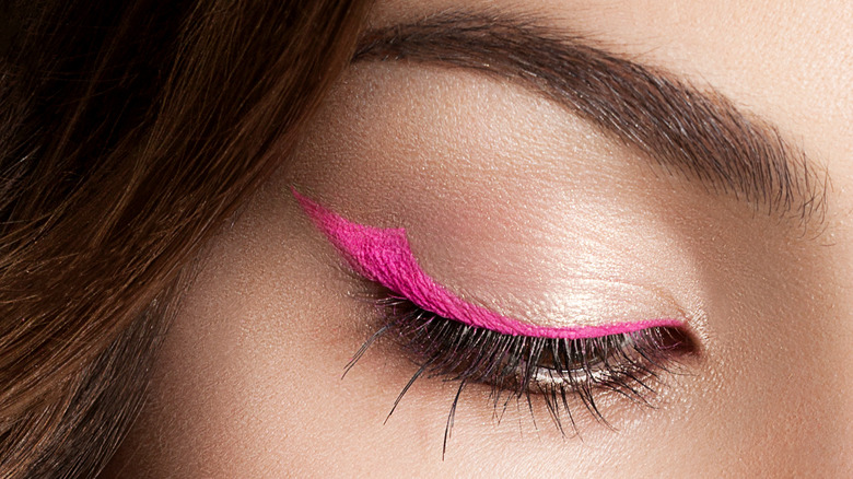 close up of woman wearing pink eyeliner 