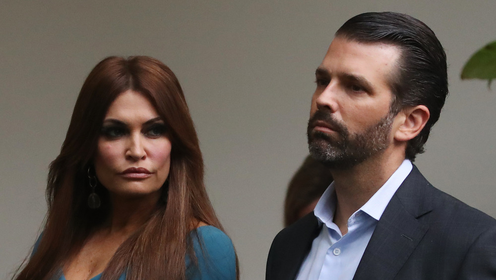 Donald Trump Jr. and Kimberly Guilfoyle together with serious expressions