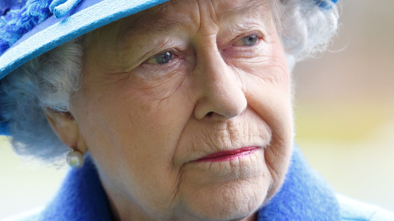 Queen Elizabeth II looking serious in blue