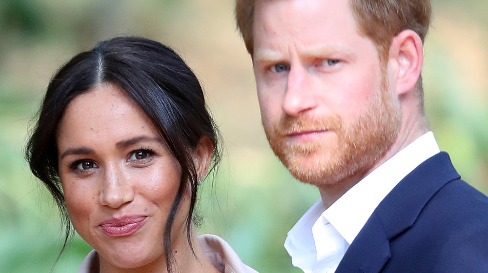 Meghan and Harry pose for an photo outdoors