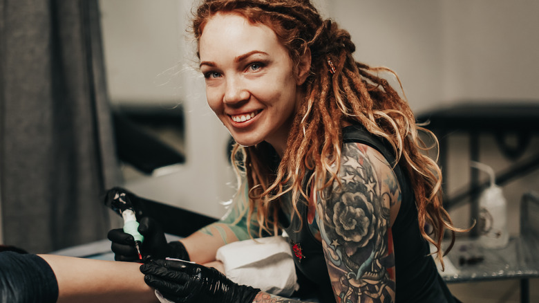 Female tattooist smiling