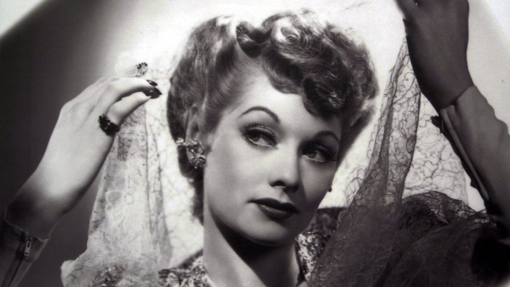 A vintage photo of Lucille Ball holding a veil