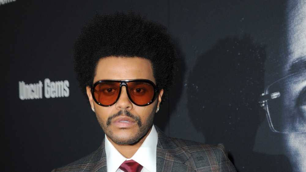 The Weeknd wears sunglasses on red carpet