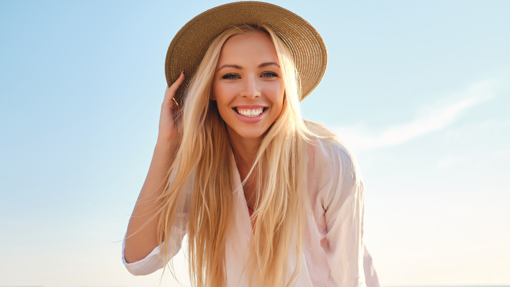 Blonde woman in hat smiling