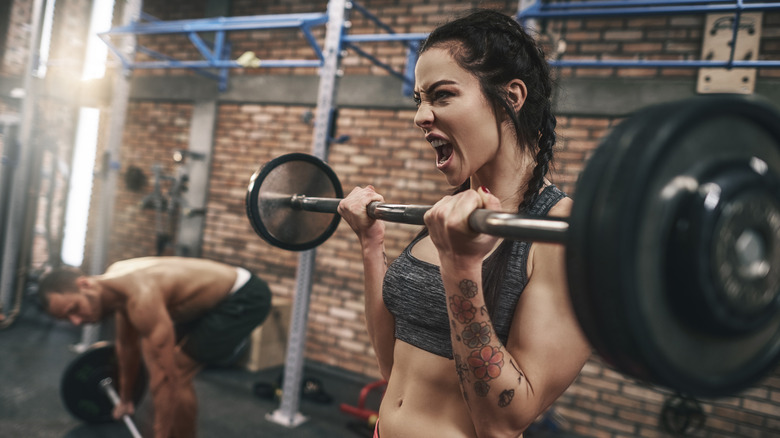 Fit woman lifting a barbell