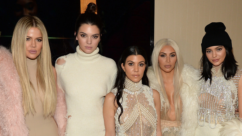 Khloe Kardashian, Kendall Jenner, Kourtney Kardashian, Kim Kardashian and Kylie Jenner posing together at an event