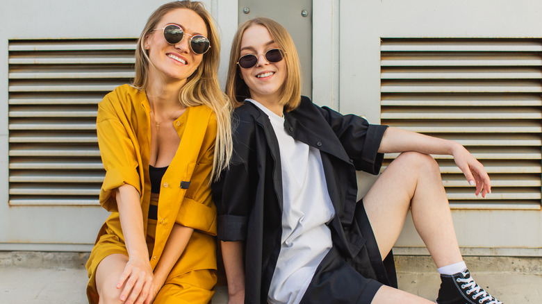 women smiling outside in sunglasses
