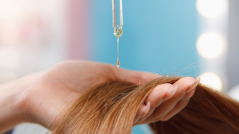 woman using hair oil