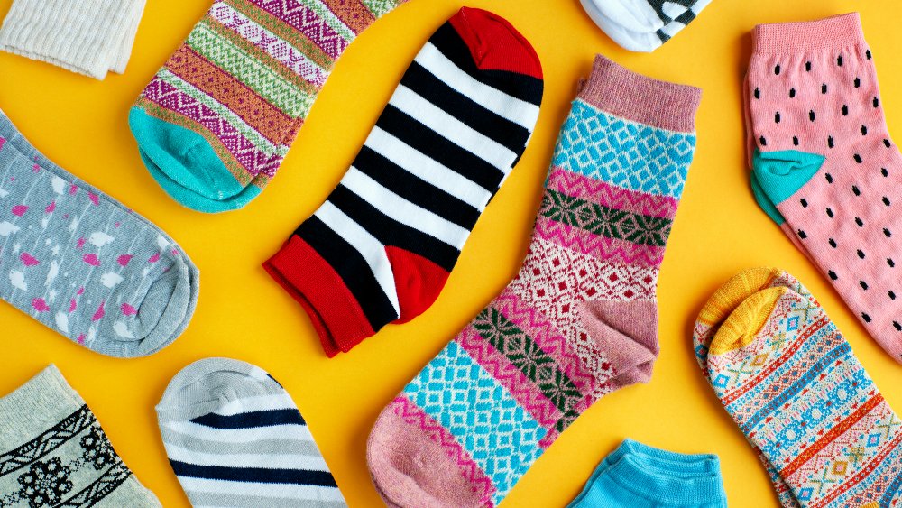 colorful patterned socks against a yellow background