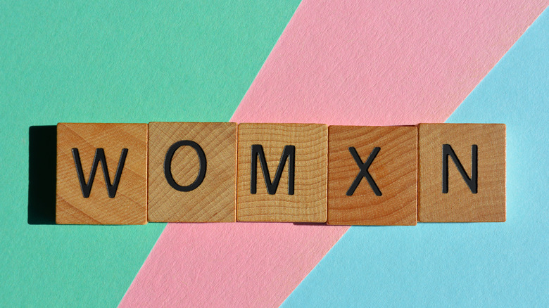 Scrabble tiles that spells out womxn
