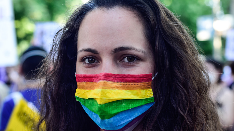 Woman wearing rainbow facemask
