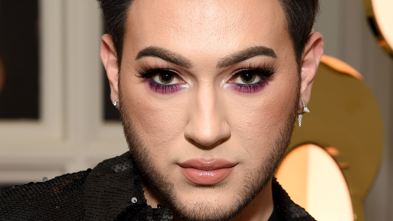 Manny MUA posing on the red carpet