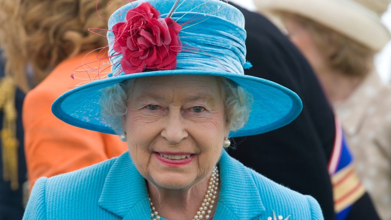 Queen Elizabeth smiling in blue