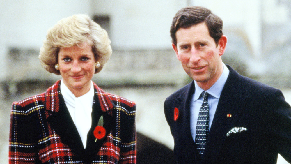Prince Charles and Princess Diana wearing red flowers