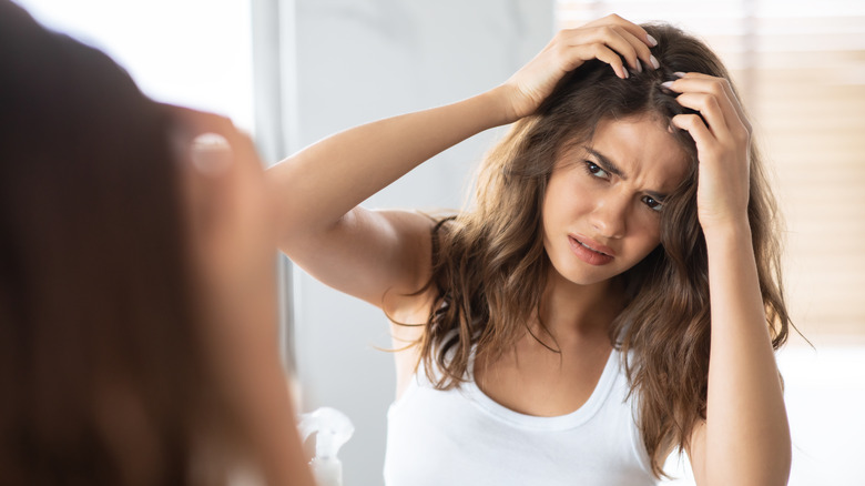 Concerned woman looking at scalp 