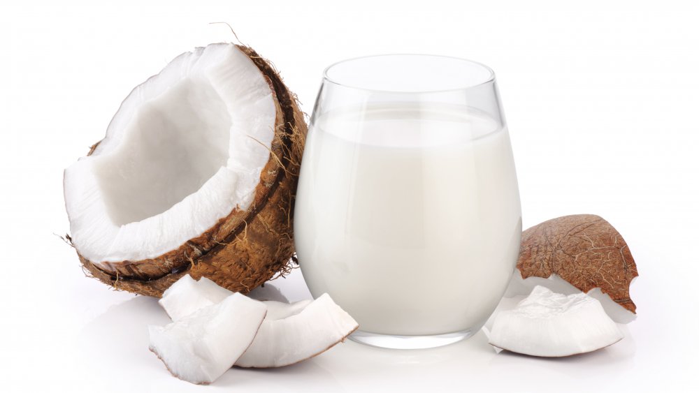coconuts with a glass of coconut milk