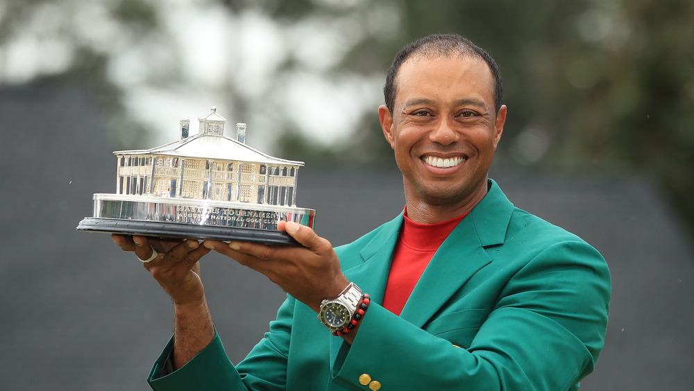 Tiger Woods posing with trophy