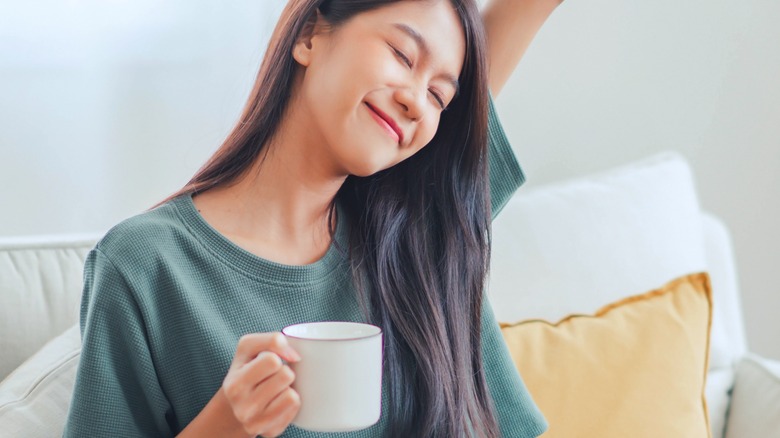 woman smiling holding coffee