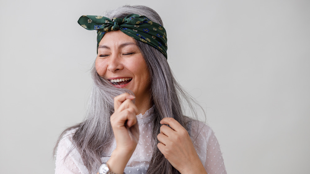 Woman with gray hair and green headband