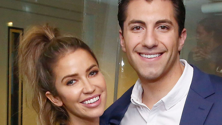 Kaitlyn Bristowe and Jason Tartick smiling at an event. 