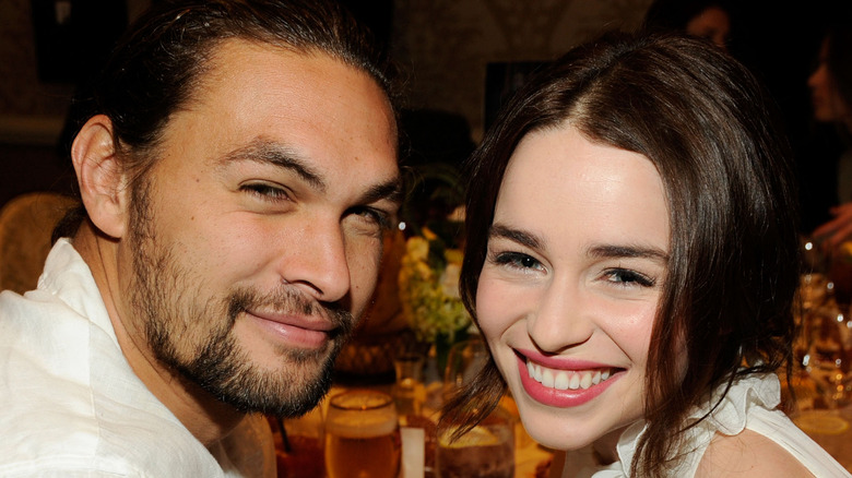 Emilia Clarke and Jason Momoa smiling for a picture