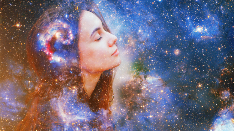 A woman's face amongst the stars and galaxies 