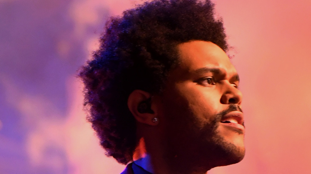 The Weeknd at Super Bowl smiling with earpiece