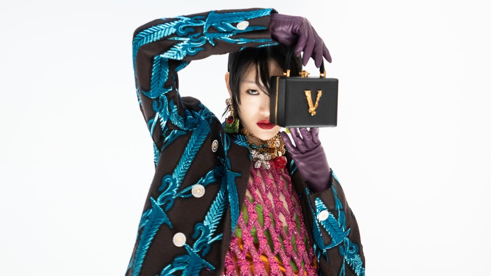 Model holding Versace bag 