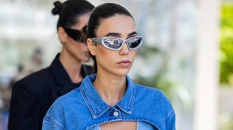Woman wearing gray wraparound sunglasses