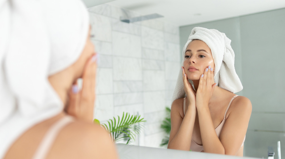 Woman applying face skin care